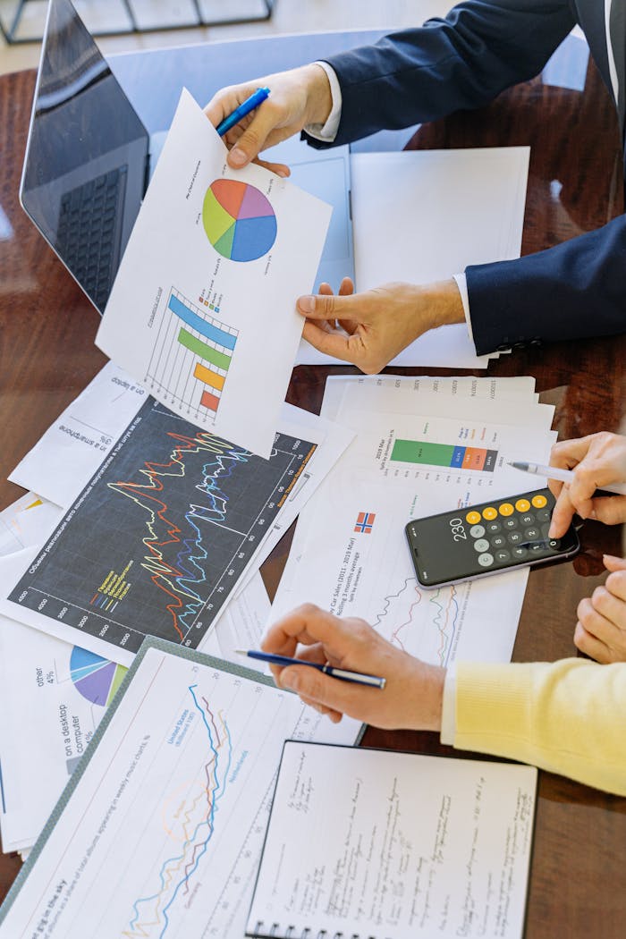 gallery-05 Business professionals analyzing financial charts and graphs during a meeting.